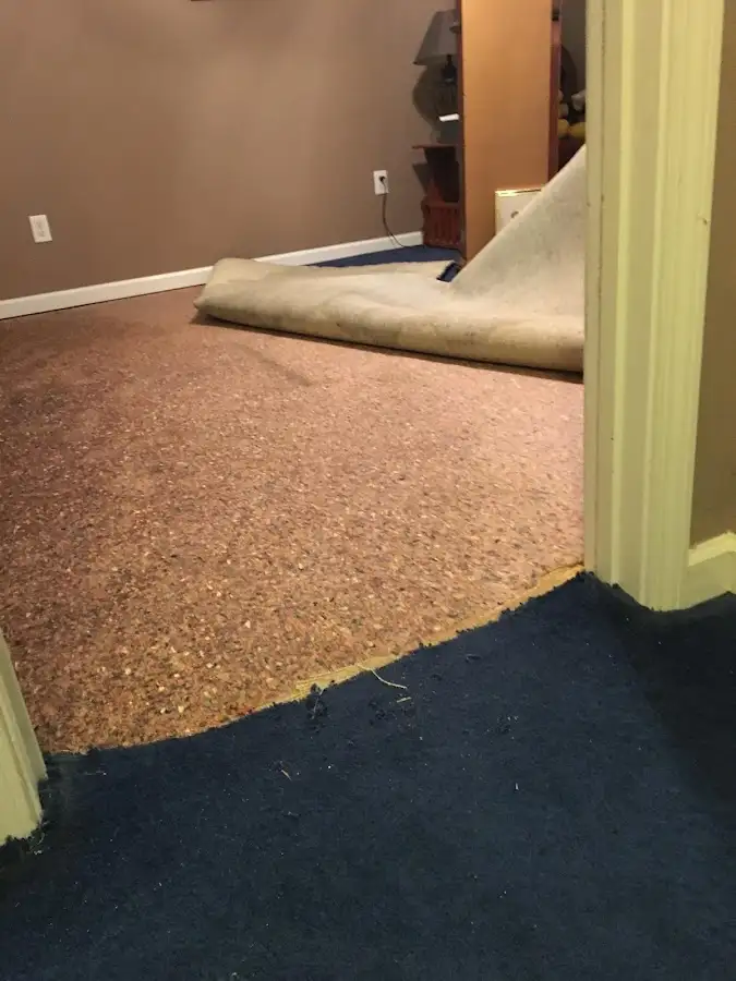 Carpet pad removal revealing water damage during Water Mitigation Services in Claremore
